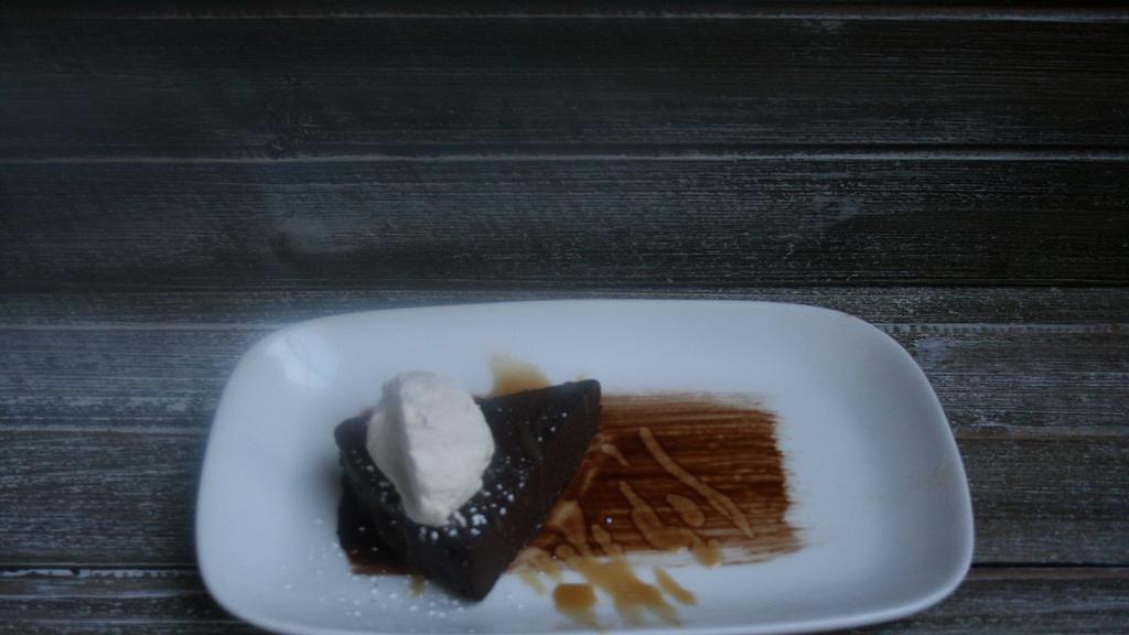 PH Flourless Chocolate Cake · Stout Whipped Cream, Caramel Drizzle, Chocolate Pearls, Fresh Berries, Cocoa Dust (GF)