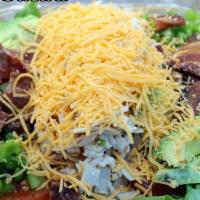 Club Salad · Turkey, bacon, avocado, tomatoes, bell peppers and shredded cheddar over a bed of lettuce.