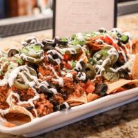 The Blvd Nachos (Half) · Beef chili, melted cheese, olives, jalapeños, pico de gallo, green onions and sour cream.