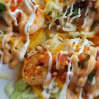 (311) Taco · Grilled shrimp seasoned with tajin, slaw, cheddar & mozzarella cheese, pico de gallo, topped...