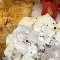 Santorini · 2 Eggs fried in extra virgin olive oil, topped with fresh cracked pepper and feta cheese, se...