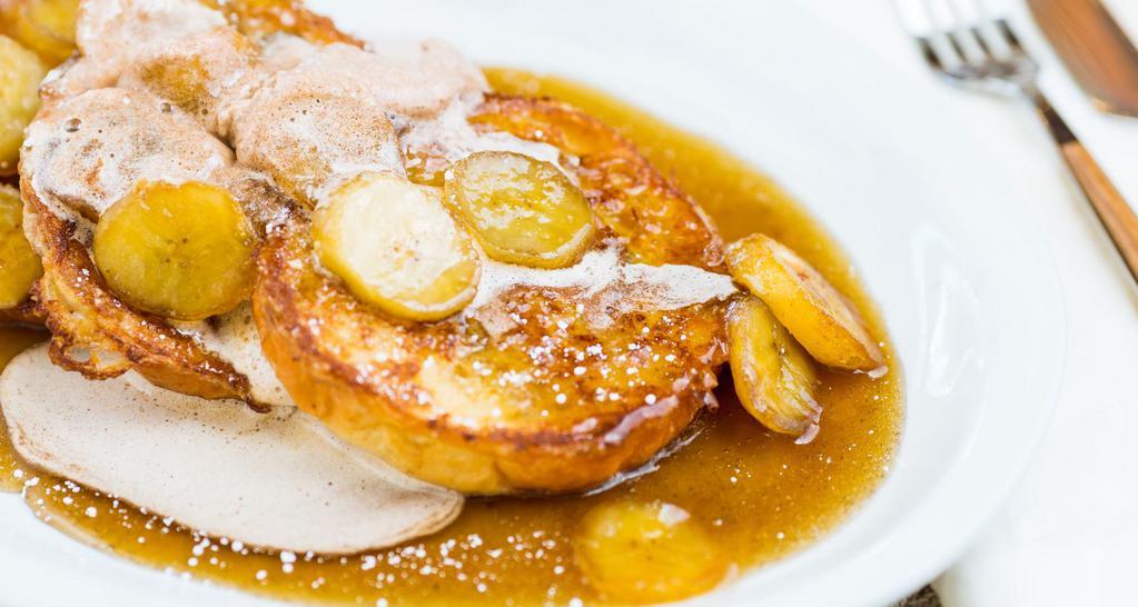 Bananas Foster · Brioche French Toast topped with caramelized bananas, fresh whipped cinnamon cream & powdered sugar