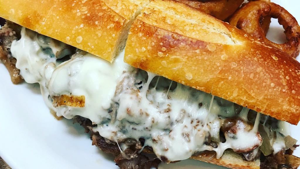 Cheese Steak · thinly sliced top sirloin, mushrooms, caramelized onions, provolone cheese, garlic roll w/ fries & mixed green salad