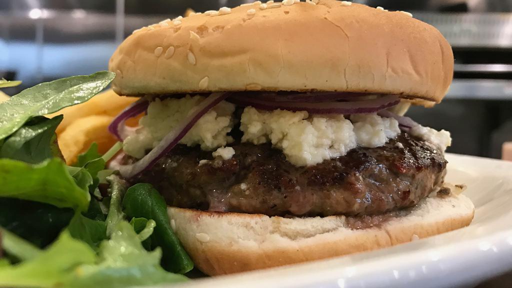 Lamb Burger · Fresh ground lamb shoulder, topped with feta cheese, red onion, cumin-lime aioli, toasted sesame bun, fries & salad