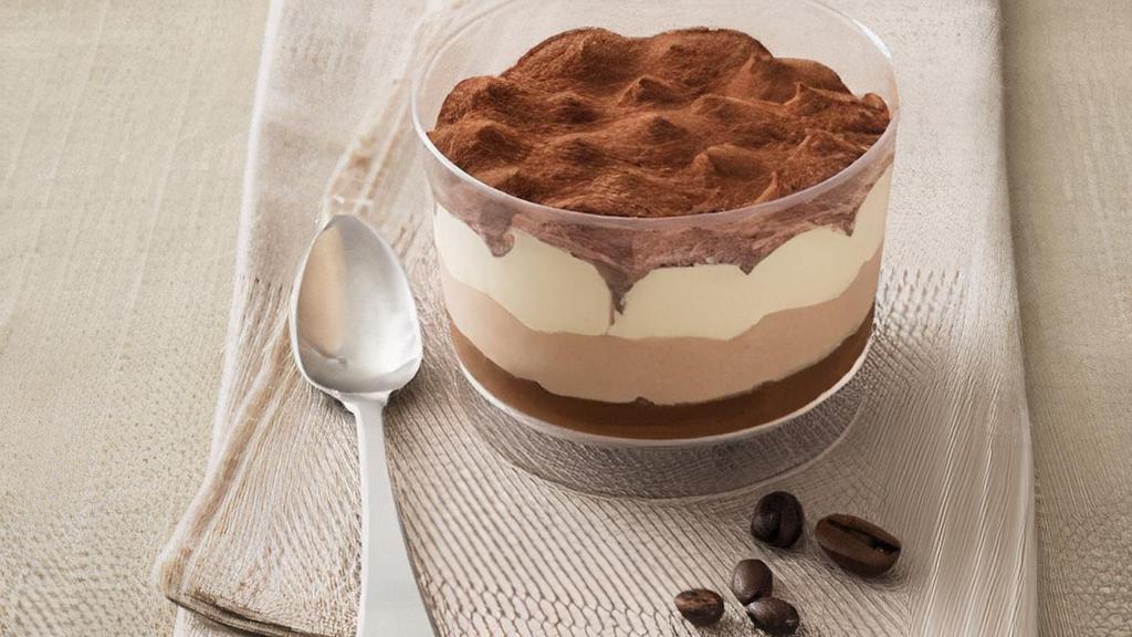 Tiramisu · Coffee and Zabaione cream on a layer of sponge cake soaked in espresso, dusted with cocoa powder
