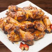 Teriyaki Wings · Oven roasted wings tossed in sweet honey and pineapple sauce. Served with a side of ranch dr...