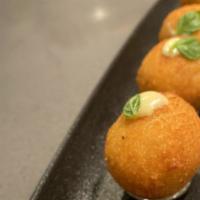 Salted Cod Cromesquis · Potato croquette with salted cod and topped with garlic aioli.
