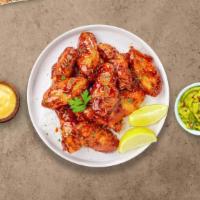 Honey BBQ Wings · Fresh chicken wings breaded, fried until golden brown, and tossed in honey and barbecue sauc...