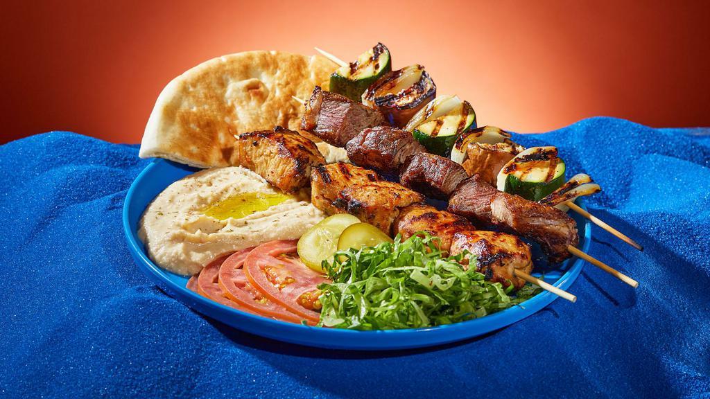 Kebab Trio Platter · Your choice of three kebabs. Served with rice or hummus, lettuce, tomato, pickles, and pita.