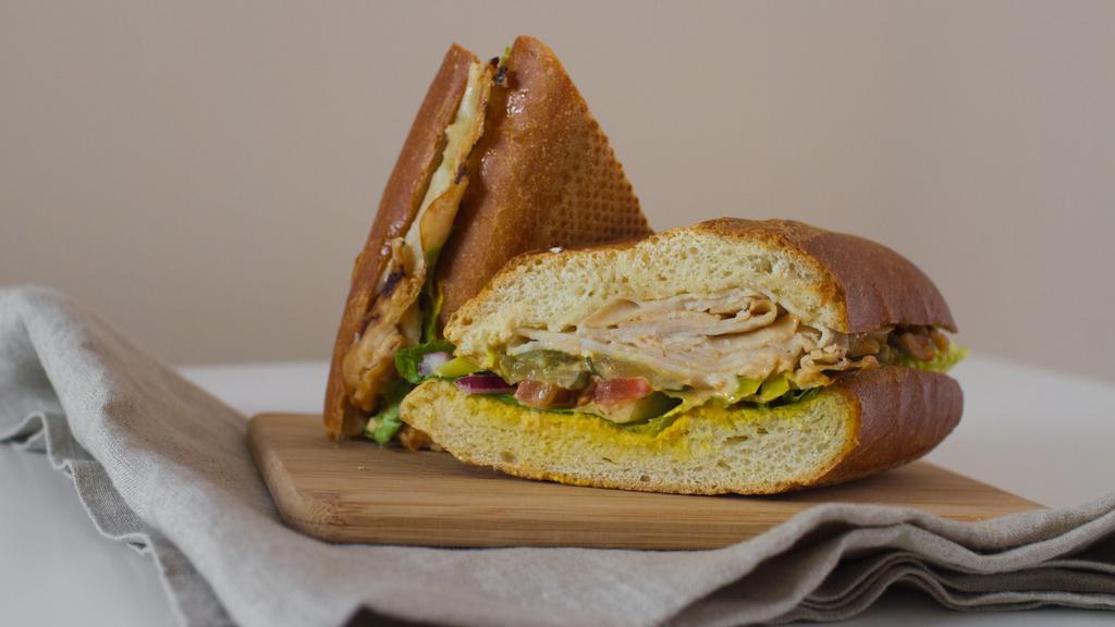 Turkey Sandwich · Smoked turkey breast, swiss cheese, avocado, jalapenos, red onion, pesto, house balsamic, lettuce, tomato.