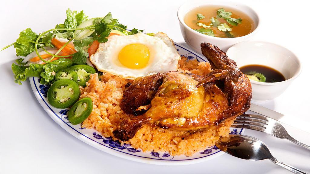 41. Cơm Chiên Gà Rô Ti · Vietnamese Style Roti Chicken with red rice and an egg