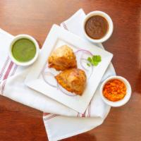 Vegetable Samosa · Mildly spiced potatoes and peas, stuffed in a light pastry.