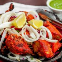 Tandoori Chicken · Chicken breast and leg marinated in spicy garlic, ginger, herbs.