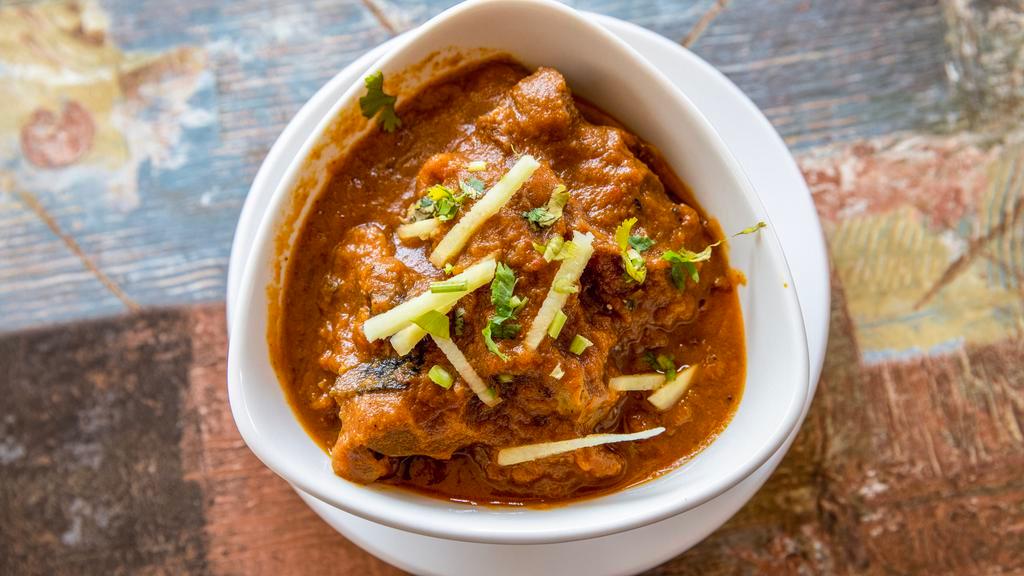 Goat Curry · Goat meat in tomatoes, onion sauce.