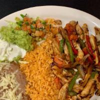 Fajitas · Your choice of strip grilled meat, bell peppers, tomatoes, onions, served with rice, beans, ...