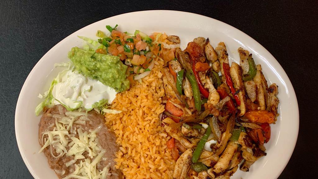 Fajitas · Your choice of strip grilled meat, bell peppers, tomatoes, onions, served with rice, beans, lettuce, cheese, sour cream, guacamole, cilantro. Corn tortillas included.
