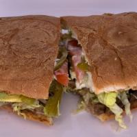 Torta · Bread filled with your choice of meat, melted cheese, fried beans, sour cream, lettuce, toma...