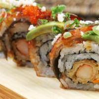 Dragon Roll · Shrimp tempura, crab meat and cucumber topped with eel, avocado, tobiko, and eel sauce.