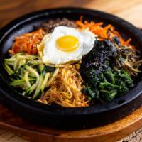 Stone Bibimbob · Rice topped on a stoneware with vegetables and a choice of protein.