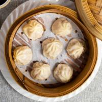 Shang Hai Style Pork Dumpling 小龍包 · Juice tender pork stuffed in dumpling skin and steamed to perfection.