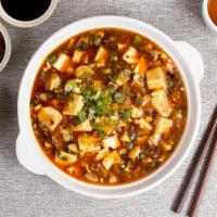 Ma Po Tofu 麻婆豆腐 · Tofu simmered and cooked in a spicy numbing curry and garnished with spring onions.