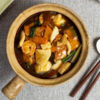 Braised Tofu with Seafood 海鮮豆腐煲 · Braised tofu and seafood cooked in a clay pot and garnished with veggies.