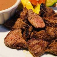 Steak Bites · Grilled and cubed marinated bistro filet served with a cabernet dipping sauce.
