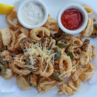 Crispy Calamari · Topped with fresh sliced jalapeño peppers, Parmesan cheese, with tangy cocktail and tartar s...