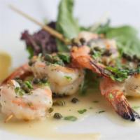 Grilled Prawn Skewers · Seven marinated prawns served with a lemon-caper butter sauce, rice, sautéed vegetables.