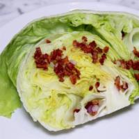 Wedge Salad · A wedge of iceberg lettuce, chopped red onion, bacon, Bleu cheese crumbles, creamy Bleu chee...
