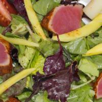 Seared Ahi Tuna Salad · Seared ahi tuna served over a bed of tossed greens with black olives, tomatoes, hearts of pa...