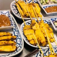 Chicken Satay · Charbroiled chicken breast marinated with Thai spices; served with peanut curry sauce and cu...