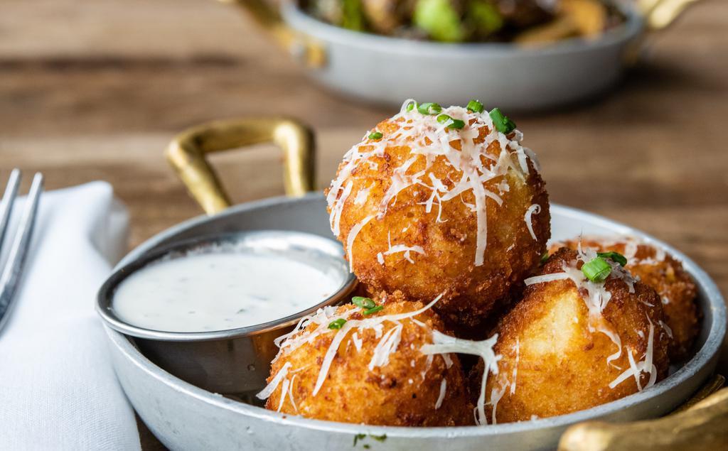 Mac & Cheese Balls · Beer cheese sauce, fresno chiles, chives, and parmesan.