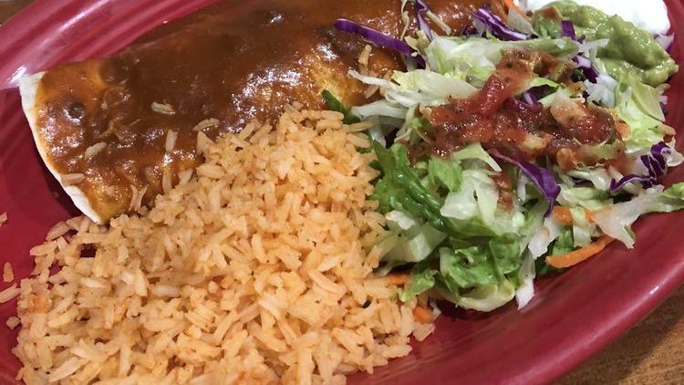 Burrito Traditional · Refried beans, jack cheese, and a choice of shredded chicken, or ground beef, or shredded beef. Cover with green and red sauce. Served with rice and Mexican salad, sour cream and guacamole.