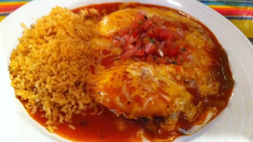 Ranchera · Shredded chicken enchilada topped with ranchera sauce.  Served with refried beans and rice.
Garnished with sour cream and guacamole.