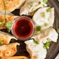 Yin Yang Dumplings · Steamed pork dumplings (4), pan-fried potstickers (4).