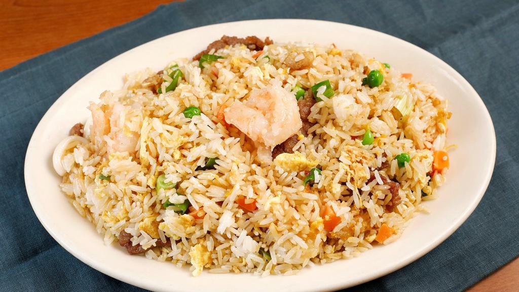 Combination Fried Rice · Jasmine white rice wok-fried with a combination of chicken, beef, and shrimp, fluffed eggs, peas, diced carrots and green onions.
