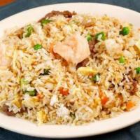 Shrimp Fried Rice · Jasmine white rice wok-fried with shrimp, fluffed eggs, peas, diced carrots, and green onions.