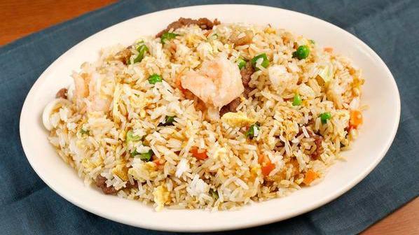 Shrimp Fried Rice · Jasmine white rice wok-fried with shrimp, fluffed eggs, peas, diced carrots, and green onions.