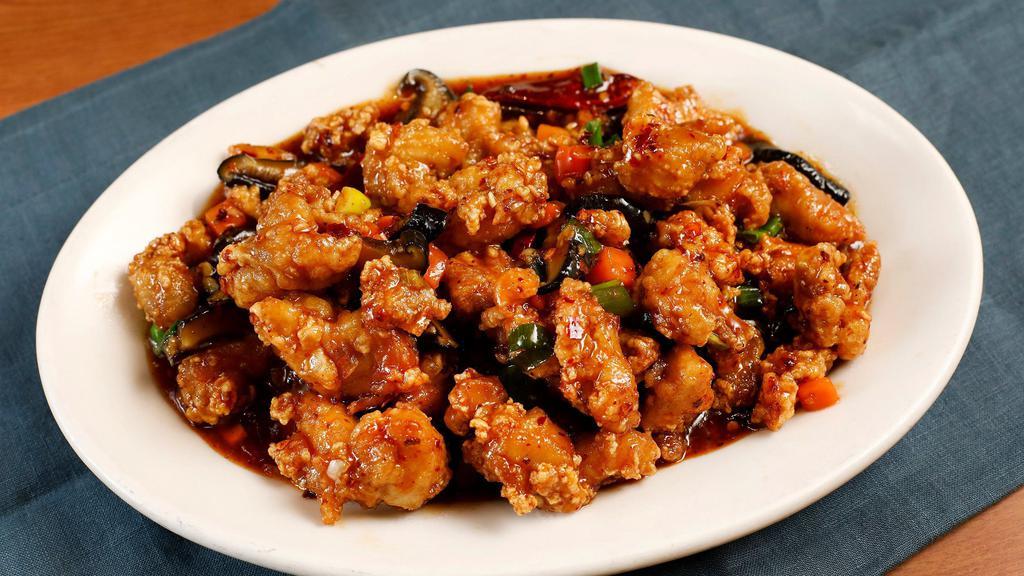 Spicy Dry Fried Chicken · Deep-fried battered chicken chunks tossed with xiao loong's sweet garlic pepper sauce. A very aromatic dish with minced ginger, garlic, chili pods, and green onions.