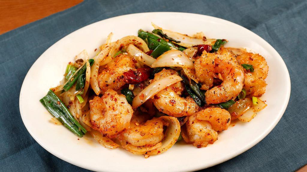 Lemon Pepper Prawns · Prawns stir-fried with sliced yellow onions, minced garlic, and a spicy lemon pepper mixture.