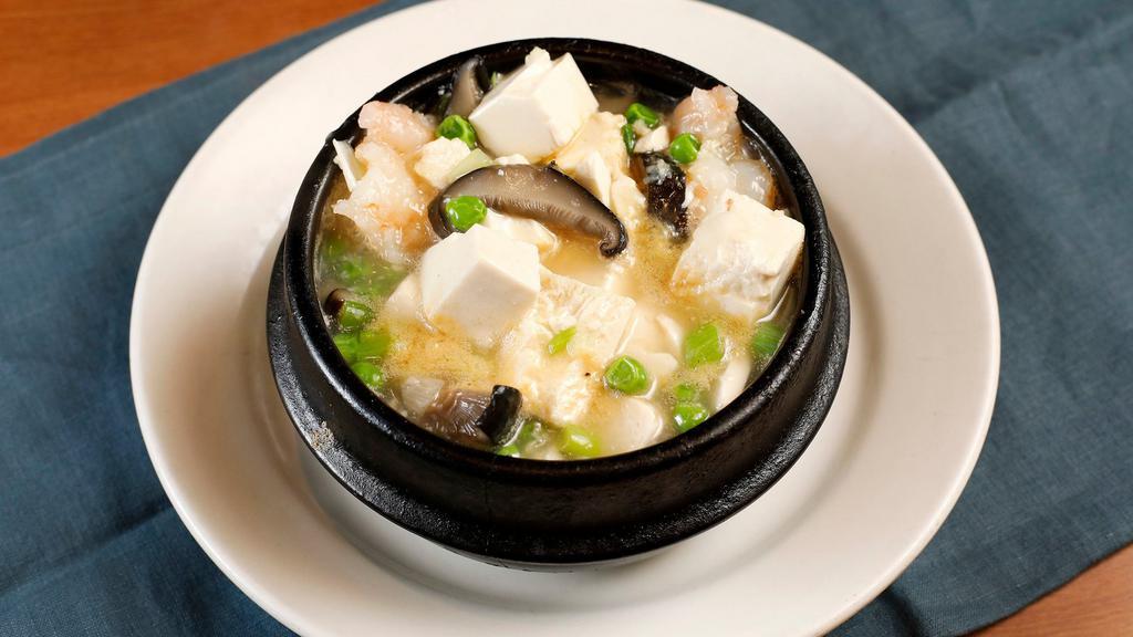 Clay Pot Prawns and Tofu · Prawns and diced tofu simmered in white wine, garlic, peas, and mushrooms. Served in a sizzling hot clay pot.