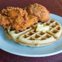 Chicken & Waffle · Two pieces of fried chicken with a waffle and syrup.