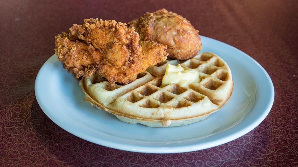 Chicken & Waffle · Two pieces of fried chicken with a waffle and syrup.