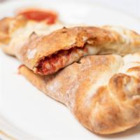 Meat Calzone · Salami, pepperoni, ham, sausage and beef. Served with mayo, mustard, lettuce, tomato and oni...