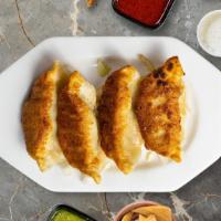 Chicken Potstickers · Served with signature dipping sauce.