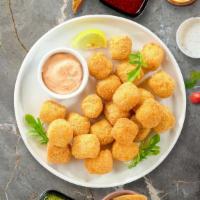 Tater Tots · Shredded Idaho potatoes formed into tots, battered, and fried until golden brown.