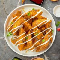Potato Wedges · Thick-cut Idaho potato wedges fried until golden brown and garnished with salt.
