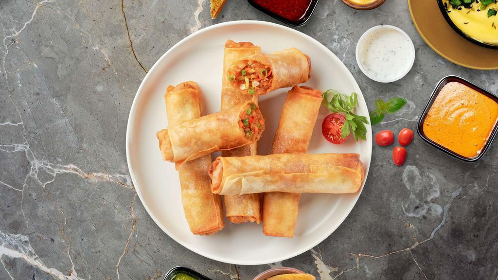 Vegetable Spring Roll · Seasonal vegetables wrapped in rice wrapper and fried until golden crisp. Served with dipping sauce.