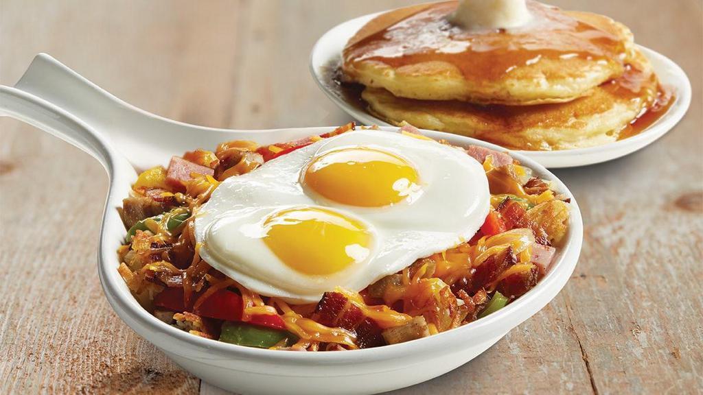 Meat Lover's Skillet · We start with a generous portion of crispy hash browns, add Applewood-smoked bacon, country ham, sausage, peppers, onions and cheddar cheese and top it all with two farm-fresh eggs*. Served with choice of breakfast side.
